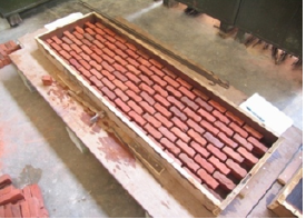 BEHAVIOR OF CENTRALLY LOADED HALF-SCALED REINFORCED BRICK SLABS